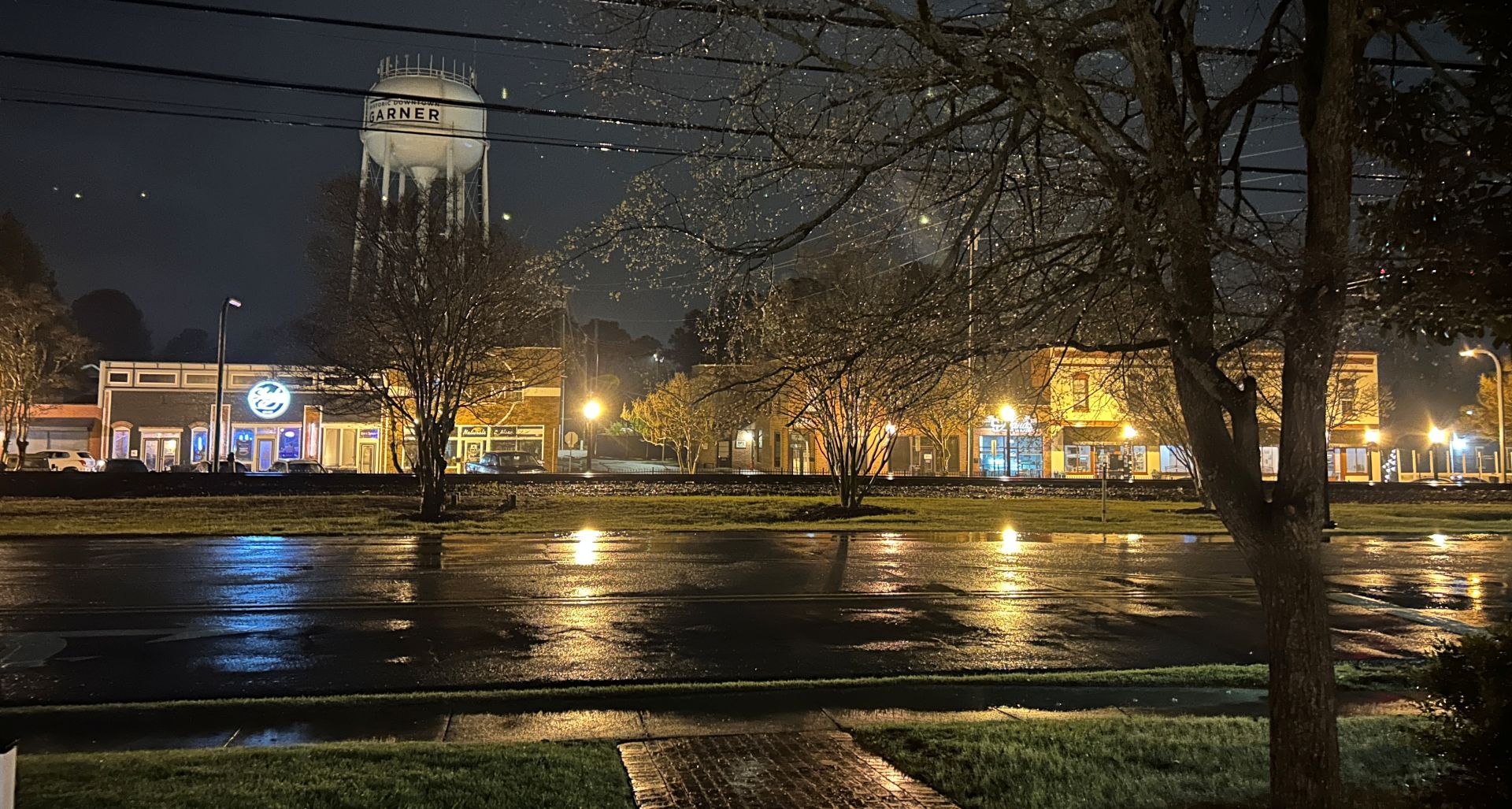 Building on Garner's Main Street at night with lights on.