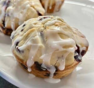 Blueberry muffin with white glaze. 