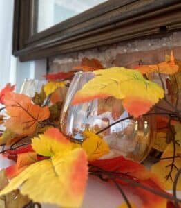 Orange and yellow leaves over glass jar. 