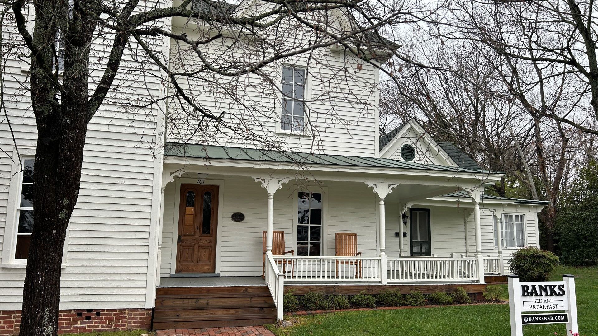 White house with porch.