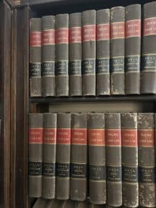 Brown law books on a shelf.