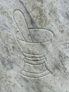 Mortal and pestle engraved on stone.