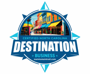 NC Destination Business logo with colorful town picture in circle.