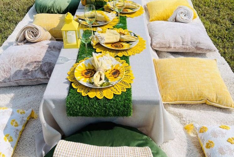 Low table outside with yellow sunflower plates
