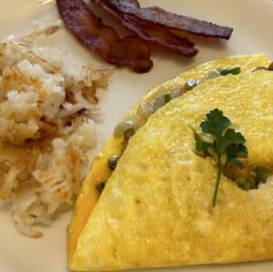 Egg omelet with bacon and hashbrowns.
